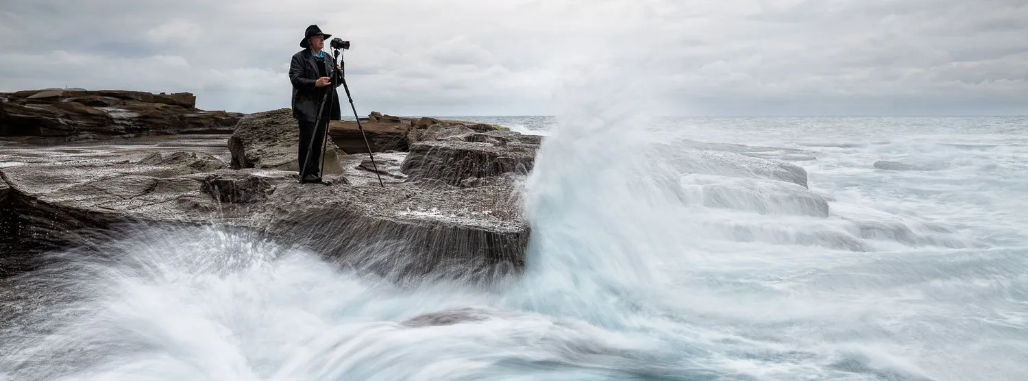Ken Duncan photographing from the rocks at Norah Head